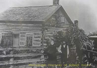 [ False Photograph of Mr. and Mrs. Donnelly, This photograph was purchased at an auction. The photograph was described as an authentic picture of James and Judith (Johannah) in front of their home.  Later, it was determined that, like many other photographs, this was not in fact a photograph of the Donnellys.  It does, however, still give us a sense of rual housing during the time period.  Thank you to Robert Salts and Ray Fazakas for this information.  By Permission of Robert Salts, Unknown, Private Collection of Robert Salts  ]