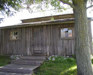 [ Back View of the Cabin at the Lucan Area Heritage and Donelly Museum, This cabin was moved to Lucan from Port Elgin, Ontario.  Though not identical to the Donnelly cabin, it is very similar.  Copyright Great Unsolved Canadian Mysteries Project, Jennifer Pettit,   ]