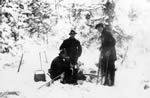 Men having lunch, in the woods, in winter time