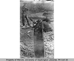 Mining operation showing four men with gold pan and sluice, Bonanza Creek