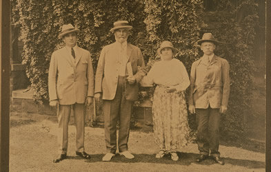 [ Verigin and Mary Strelaeff with community officials Max Baskin (left) and Fyodore Hlookoff (right), Unknown, UBC Special Collections 52-28 ]