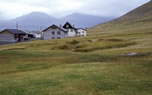 Ruins of a Viking Age church surrounded by a sub-circular cemetery wall at Leirvik, the Faeroes Islands.