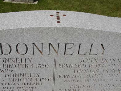 [ Pennies on top of the Donnelly Tombstone at St. Patrick's Roman Catholic Cemetery, Biddulph, 2005, The 