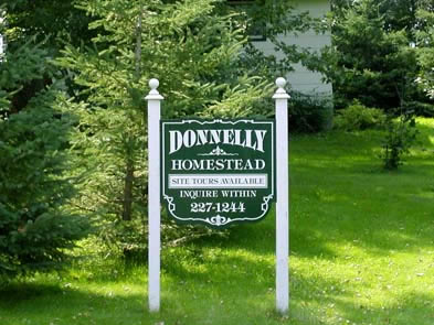 [ Sign Advertising Tours of the Donnelly Homestead, 2005, Interest in the Donnelly murders remains high.  So much so, in fact, that Robert Salts gives regular tours of the Donnelly homestead to tourists and school groups.  Thanks to Robert Salts, present-day owner of the Donnelly Homestead, who allowed this photograph to be taken.  Copyright Great Unsolved Canadian Mysteries Project, Jennifer Pettit,   ]