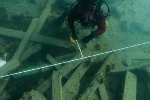 The diver is positioning reference lines in the debris field near the Erebus wreck