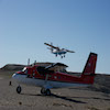 Blue Twin Otter Taking Off and Red Twin Otter in Foreground