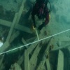The diver is positioning reference lines in the debris field near the Erebus wreck