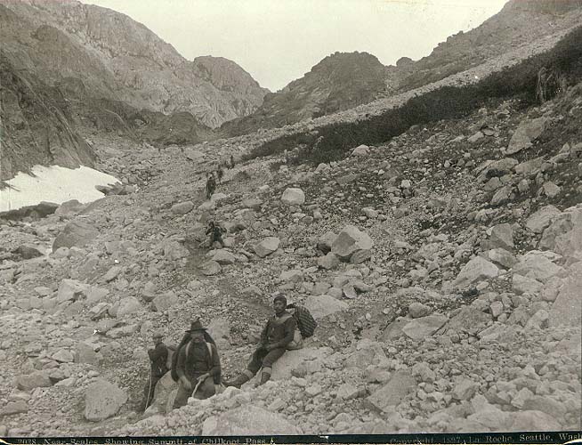 [   Klondikers and native packer near The Scales looking north toward the summit of Chilkoot Pass ]
