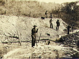[ Gold miners operating sluice on claim No. 39 below Hunker Creek ]