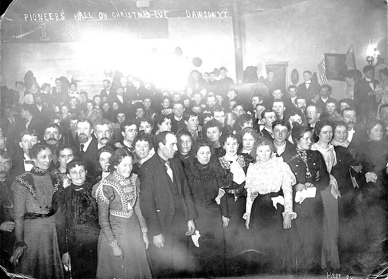 [ Men and women celebrating Christmas Eve in Pioneer Hall, Dawson ]